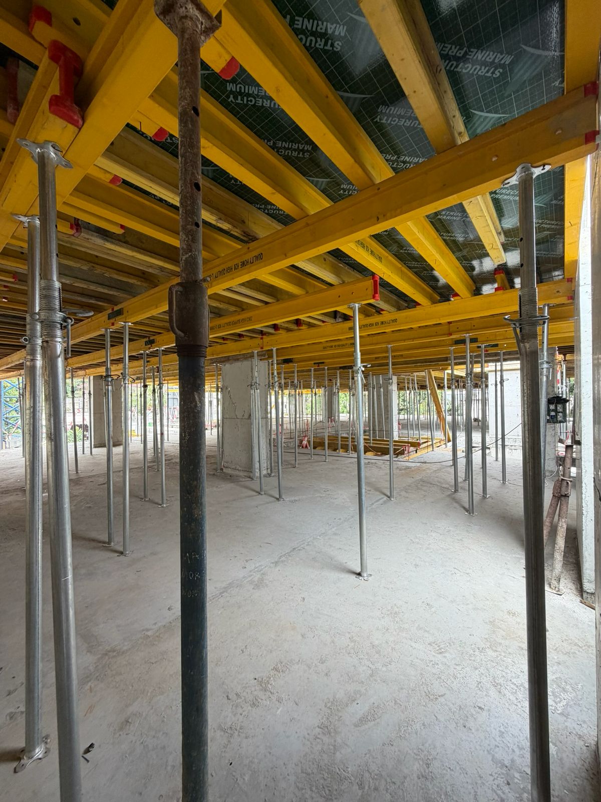 Slab formwork and steel props on a CAJIS construction site
